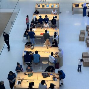 A dynamic interior view of a tech store with people engaging in Kuala Lumpur mall.